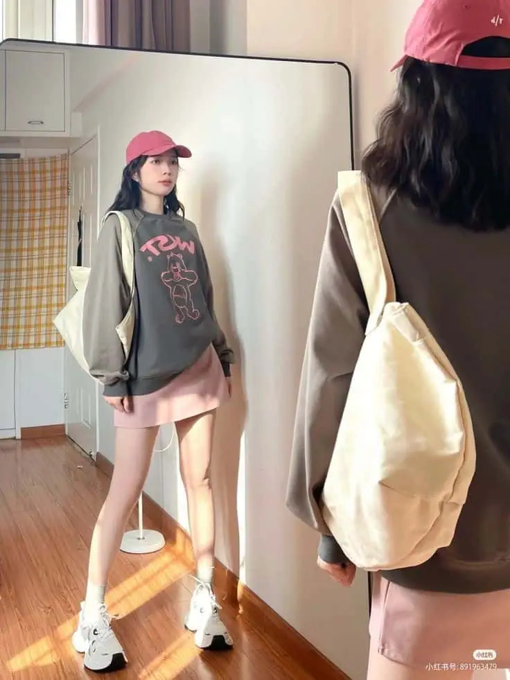 Pink Cap with Graphic Sweatshirt Look